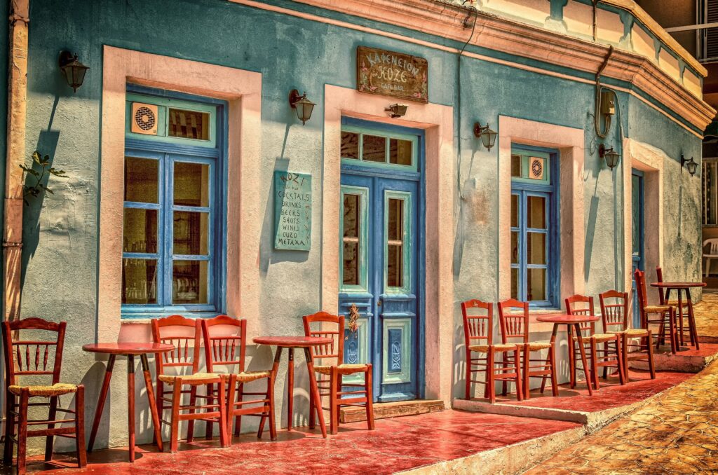 An image showing cafe with wooden chairs outside