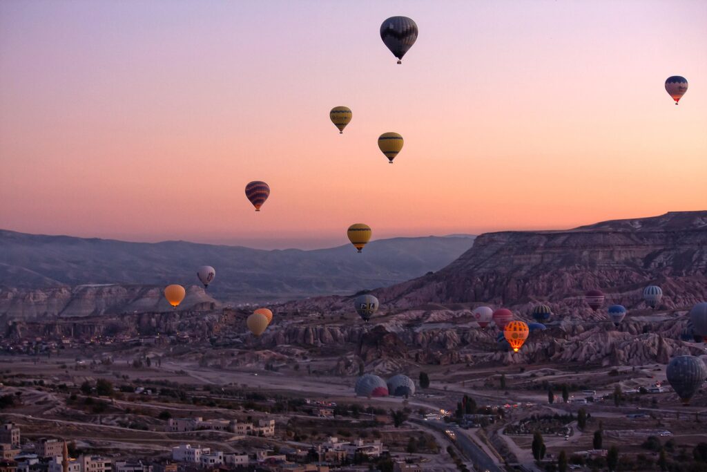 An image showing hot air balloons were flying in the air at Cappadocia, Turkey.