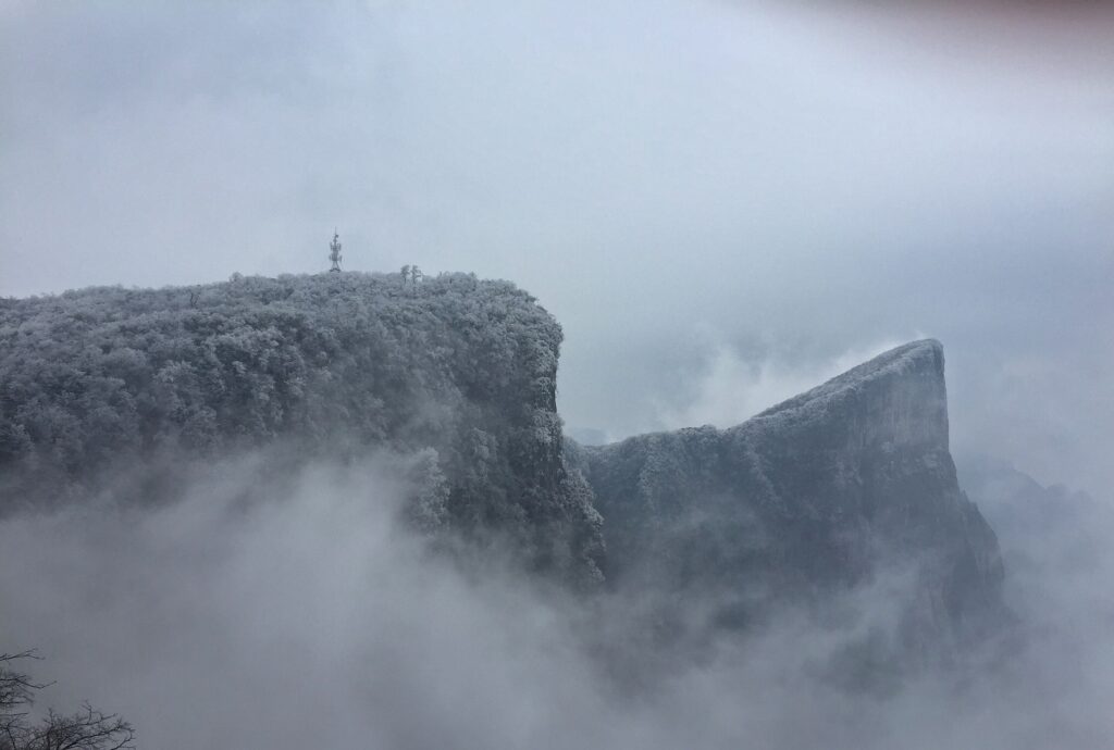 An image showing Zhangjiajie National Forest Park covered with dense fog 